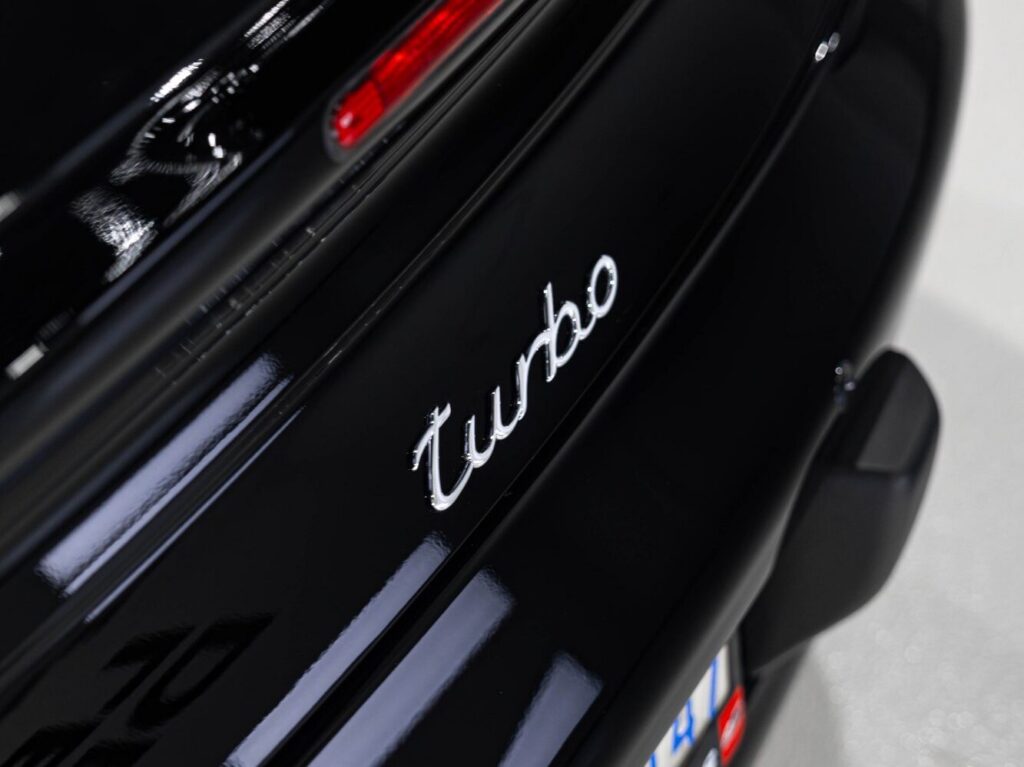 Glossy rear Turbo badge on a black Porsche 911 Turbo after System X ceramic coating