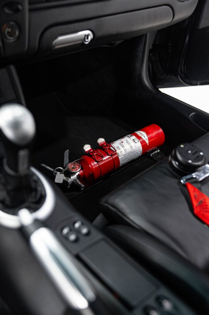 Mounted fire extinguisher inside a track-prepared Porsche 911 Turbo